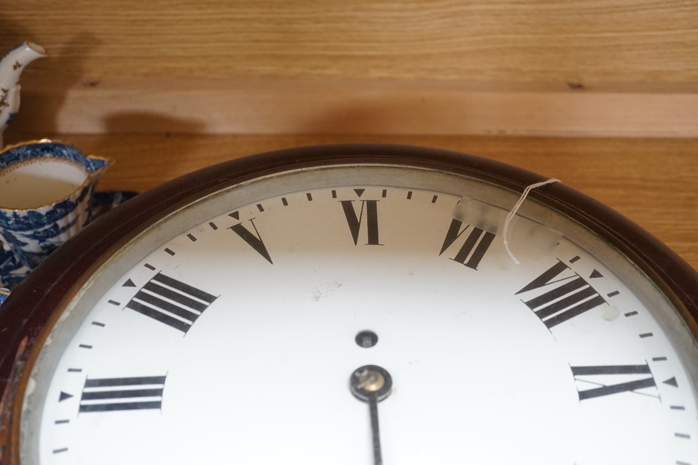 An early 20th century mahogany circular wall clock, single fusee movement, 41cms wide